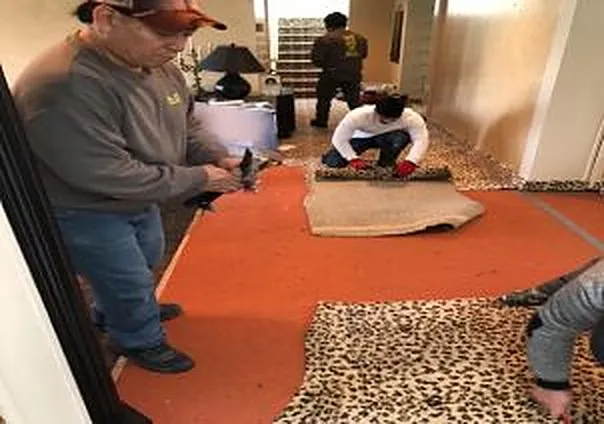 REA Floors crew pulling up water-damaged carpet and padding