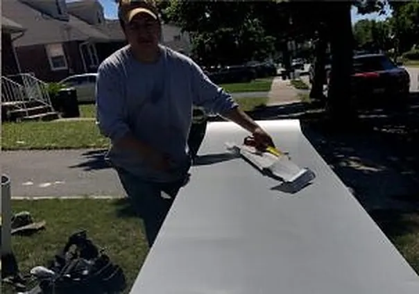 REA Floors technician cleaning a rug outside a customer's home